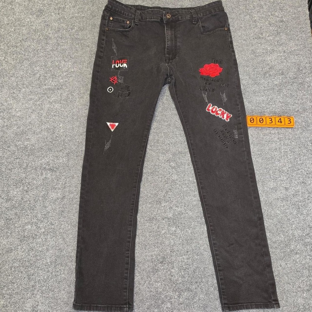 Fashion Denim Black denim jeans with red rose graphic and text patches. Size 34